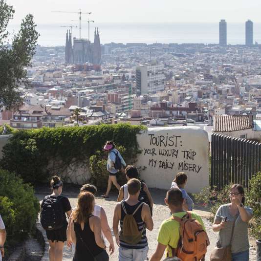 A graffiti against tourists is seen at the Guell Park in Barcelona, Spain, on 07 august 2017. The so called 'tourist phobia' is rising amongst some people in Barcelona against the massive number of tourist visiting the city. The Association of Hotels in Barcelona has demanded action against this type of vandalic acts related to the 'tourist phobia'. According to hotels, the recent 'hate' towards tourists is totally related to the flats rented illegally to tourists. EFE/Quique Garcia//EFE_20170807-636377144270121956/Credit:Quique García/SIPA/1708071505